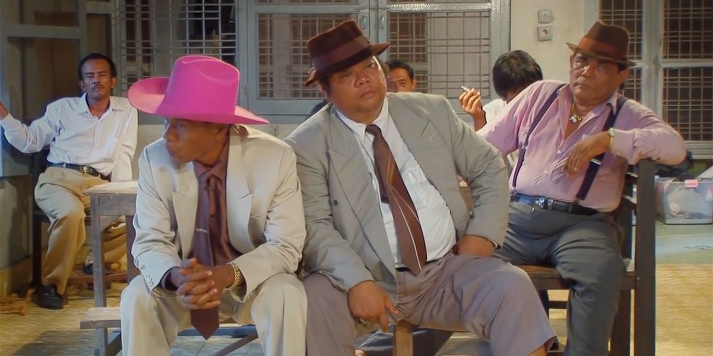 Men sitting together while recreating a film noir in The Act of Killing