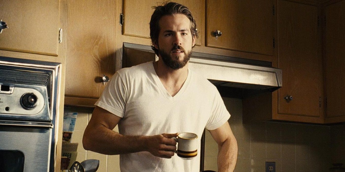 George (Ryan Reynolds) holding coffee in 'The Amityville Horror'