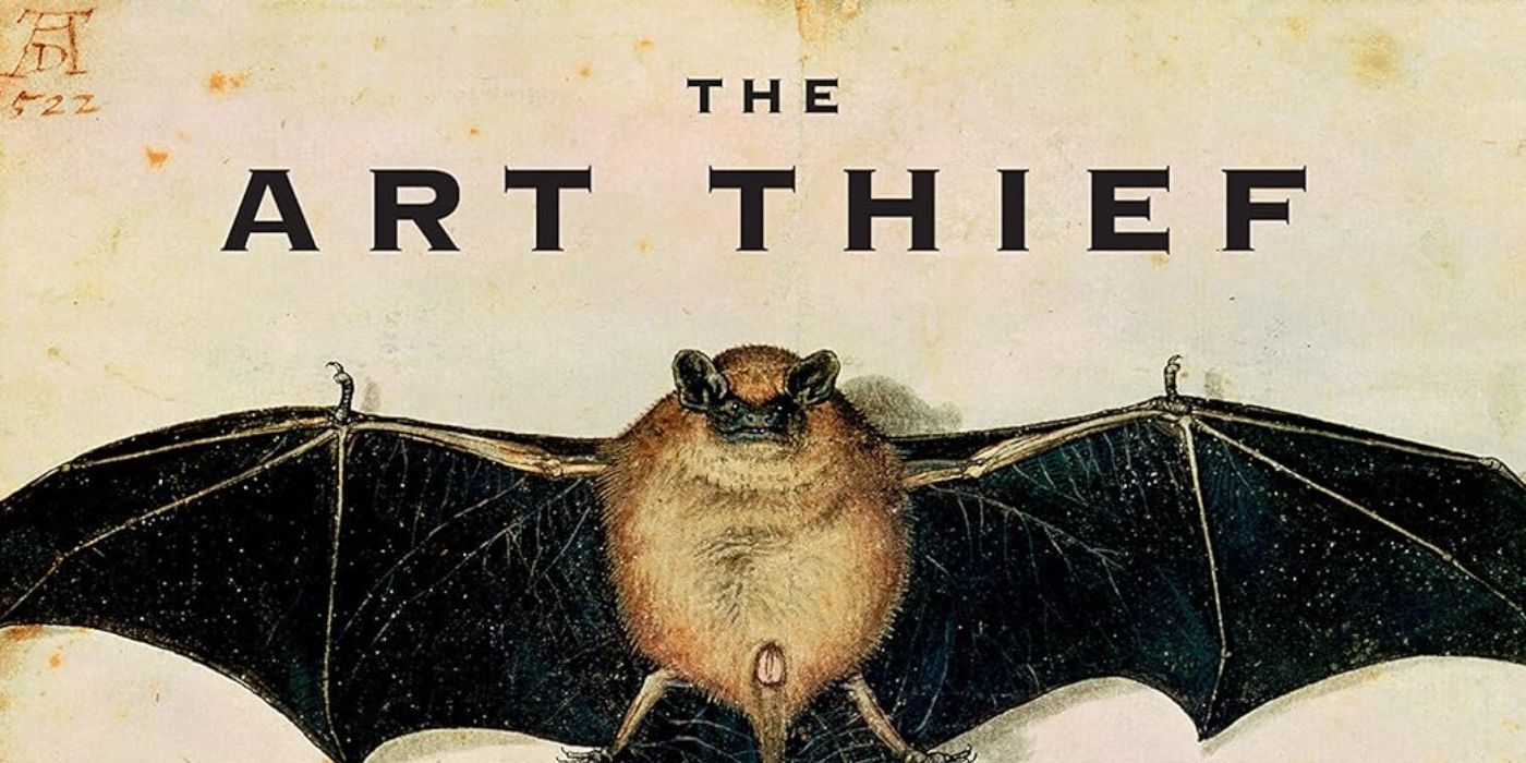 A brown bat with black wings lays down on its back with its wings spread out. The words, "The Art Thief," are above its head in black typeface. 