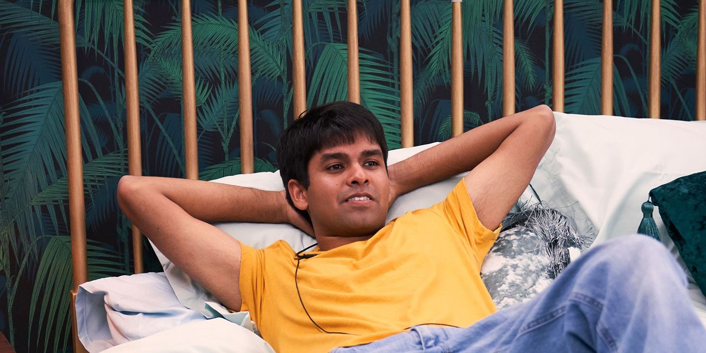 Shubham from The Circle lying on a chair outside, arms behind his head looking comfortable.