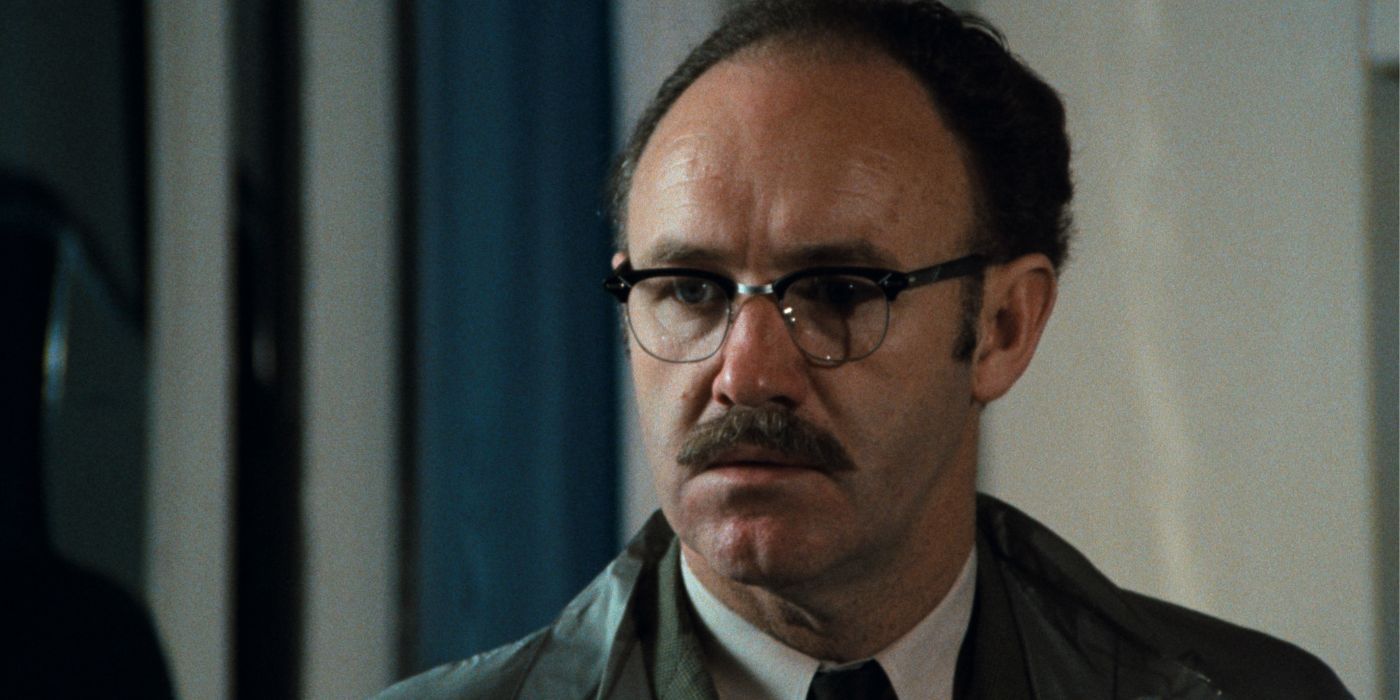 Gene Hackman, with a mustache and glasses, looking concerned at something off camera in The Conversation.