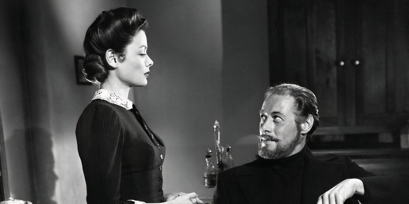 Lucy Muir (Gene Tierney) standing and staring imperiously down at Daniel Cregg (Rex Harrison), who's sitting and staring up at her with a wry expression in The Ghost and Mrs. Muir