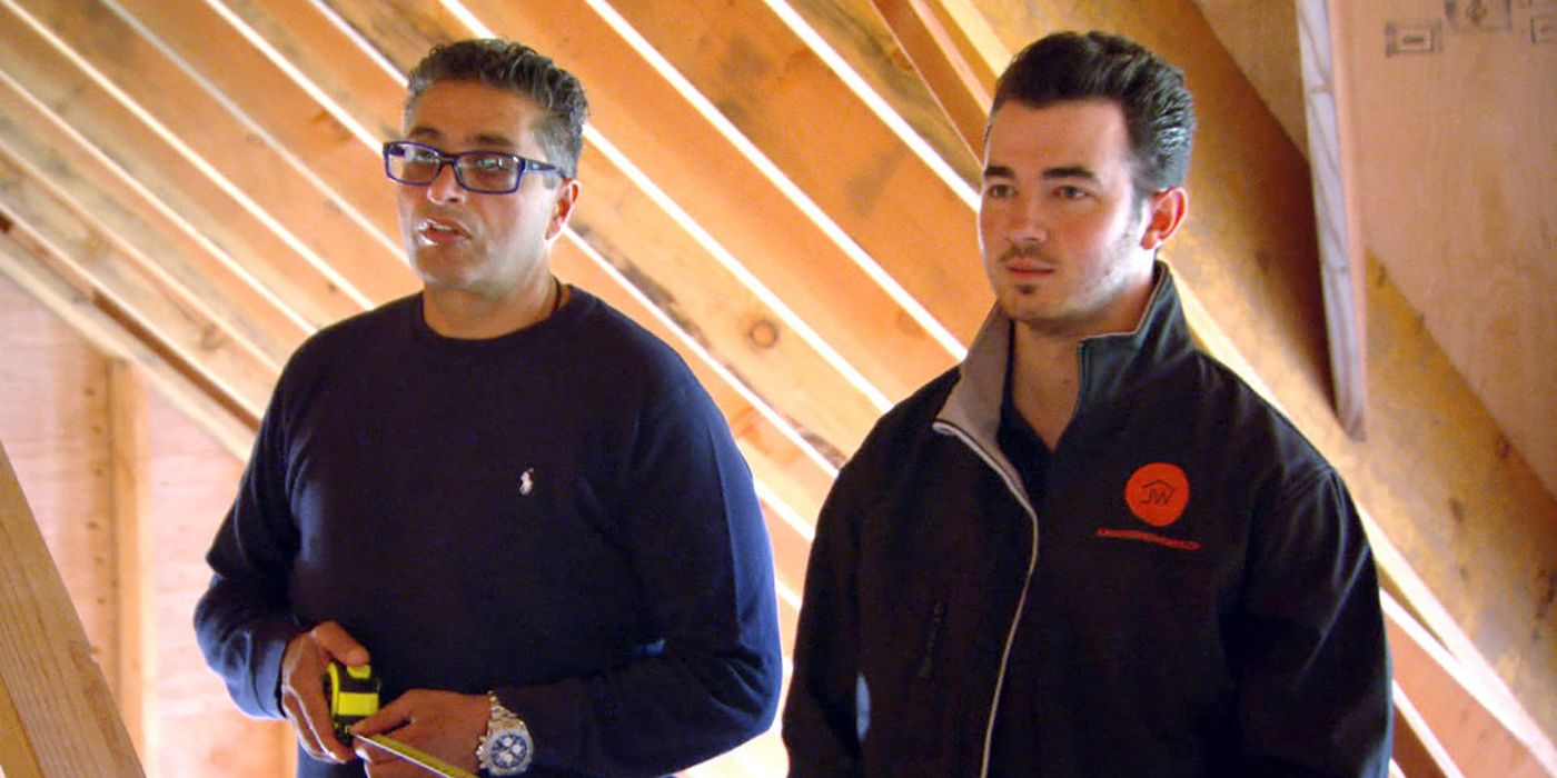 Kevin Jonas standing with another man in a home in a scene from The Real Housewives of New Jersey.