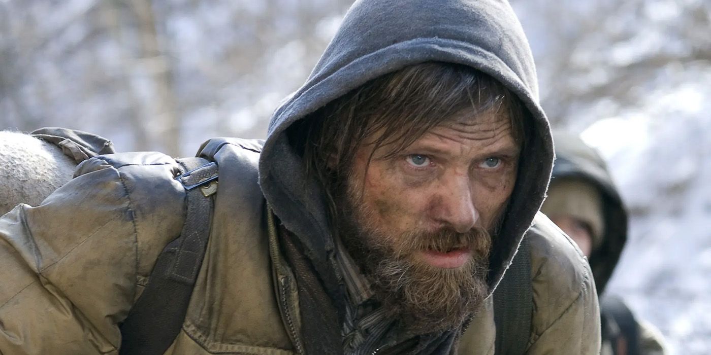 The Man (Viggo Mortensen) protects his son in &lsquo;The Road.'