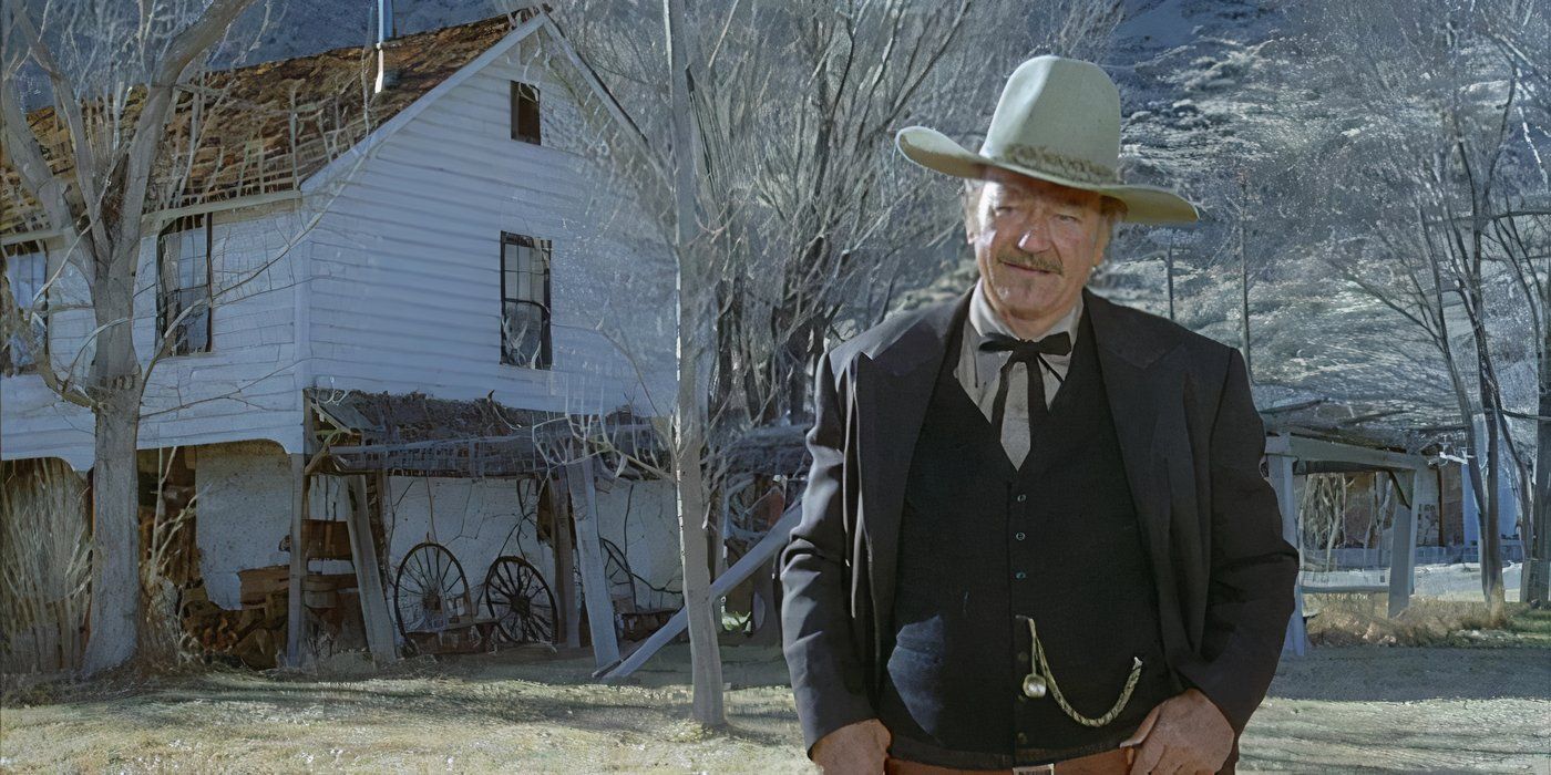 John Wayne standing outside looking at someone off camera in The Shootist