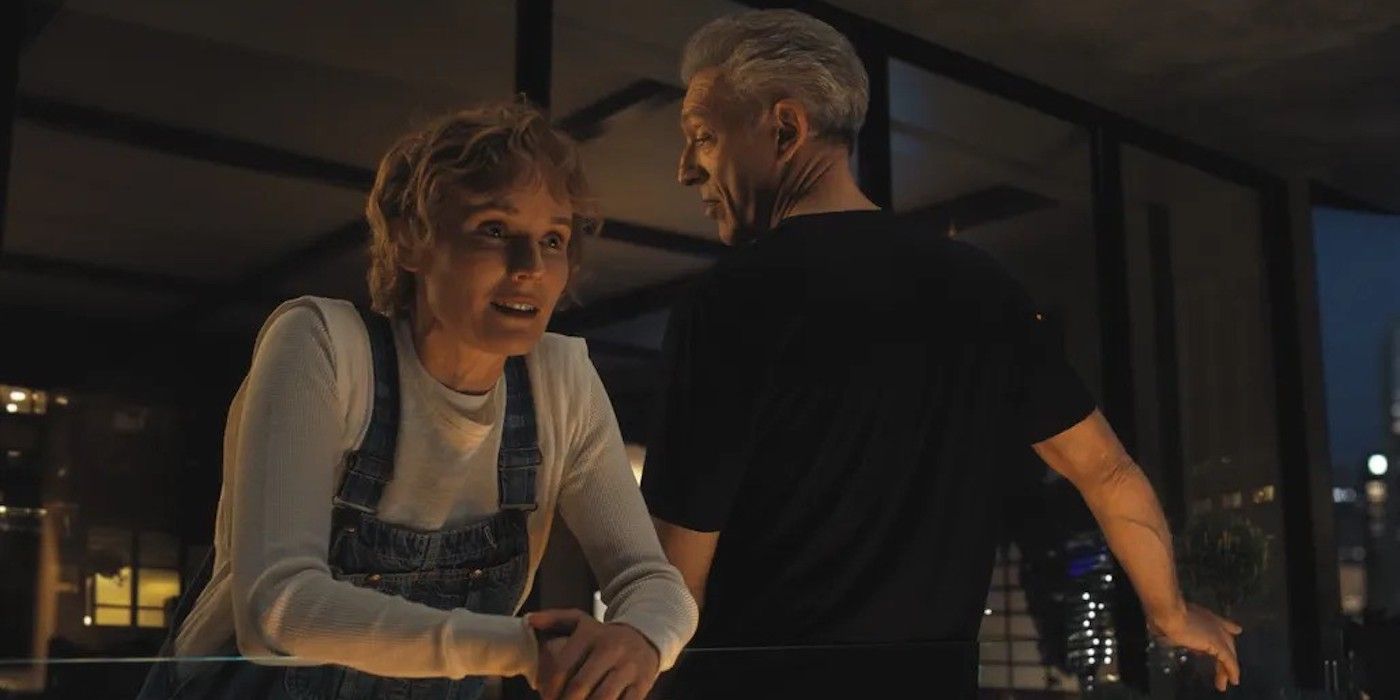 Vincent Cassel and Diane Kruger talking on a balcony in The Shrouds. 