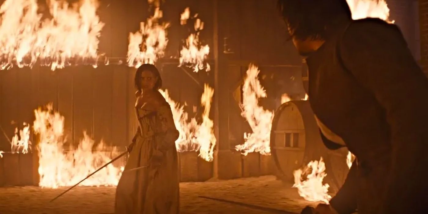 Eva Green surrounded by fire while holding a sword in The Three Musketeers - Part II: Milady