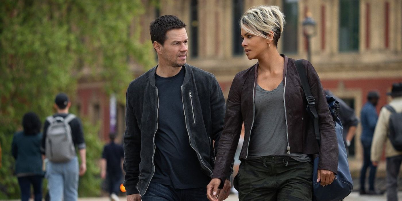 Mark Wallberg walking next to Halle Berry in the middle of university campus in 'The Union' still image.