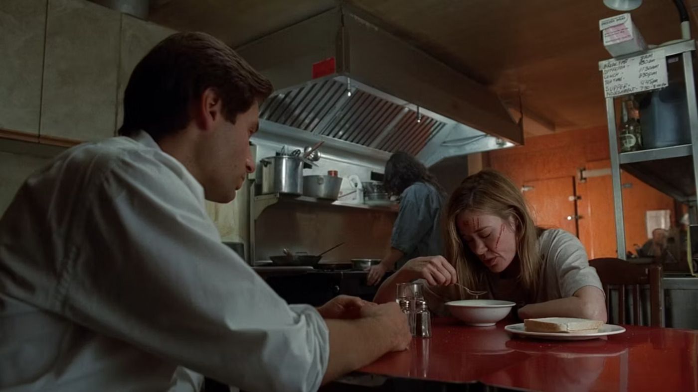 Two People Sitting at a table in a diner. 