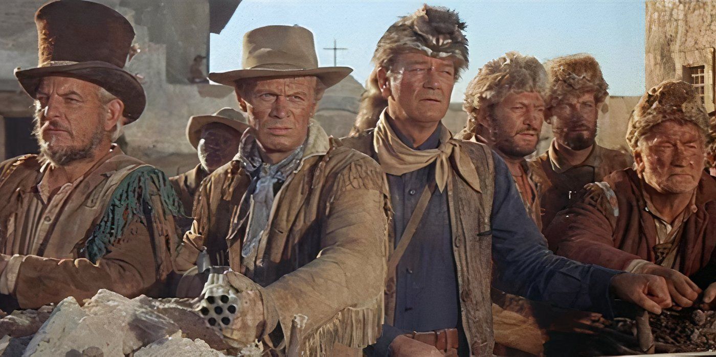 Davy Crockett (John Wayne, third from left) stands with his fellow frontiersman with weapons at the ready
