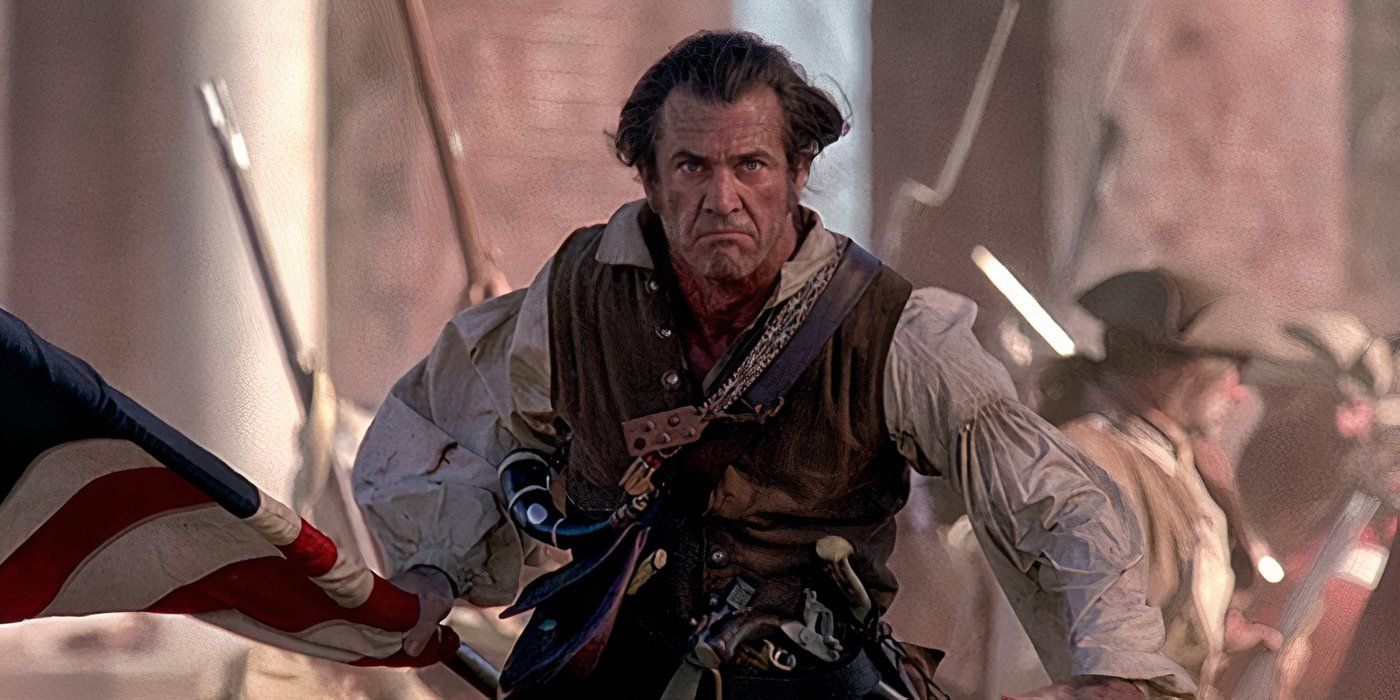 Benjamin (Mel Gibson) charges into battle carrying an American flag, with soldiers in the background