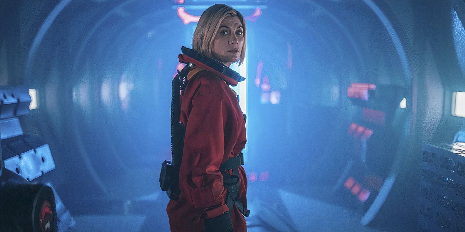 Jodie Whittaker as the Thirteenth Doctor in an orange spacesuit in a hallway