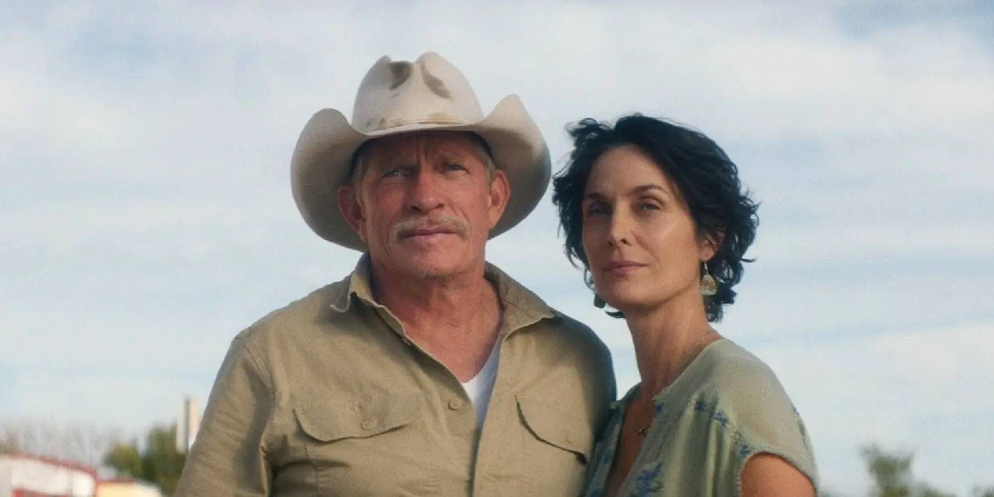 Thomas Haden Church and Carrie-Anne Moss as Merle and Faye standing side by side in Accidental Texan