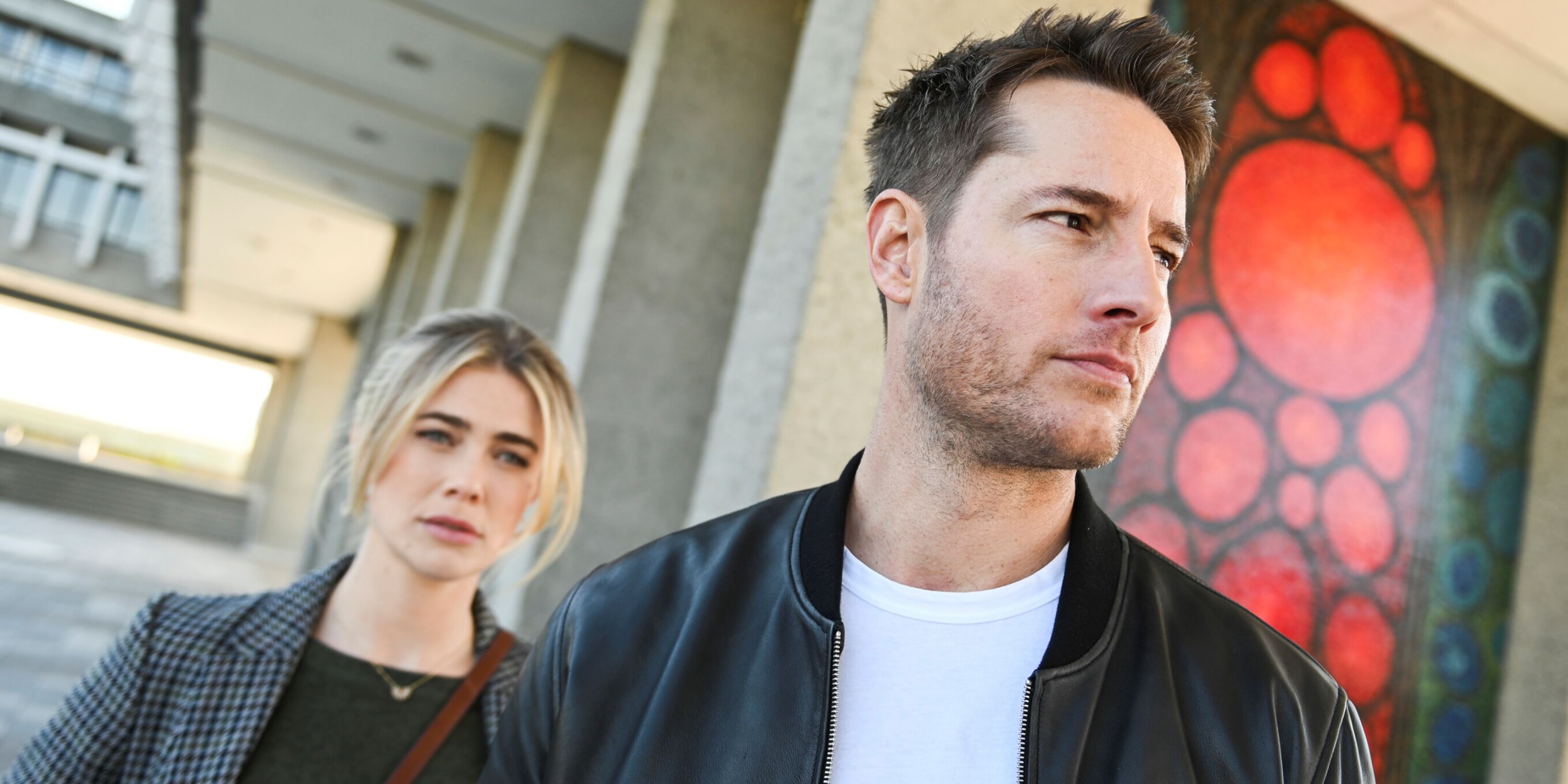 Justin Hartley as Colter Shaw standing in front of Melissa Roxburgh as his sister Dory in CBS' Tracker