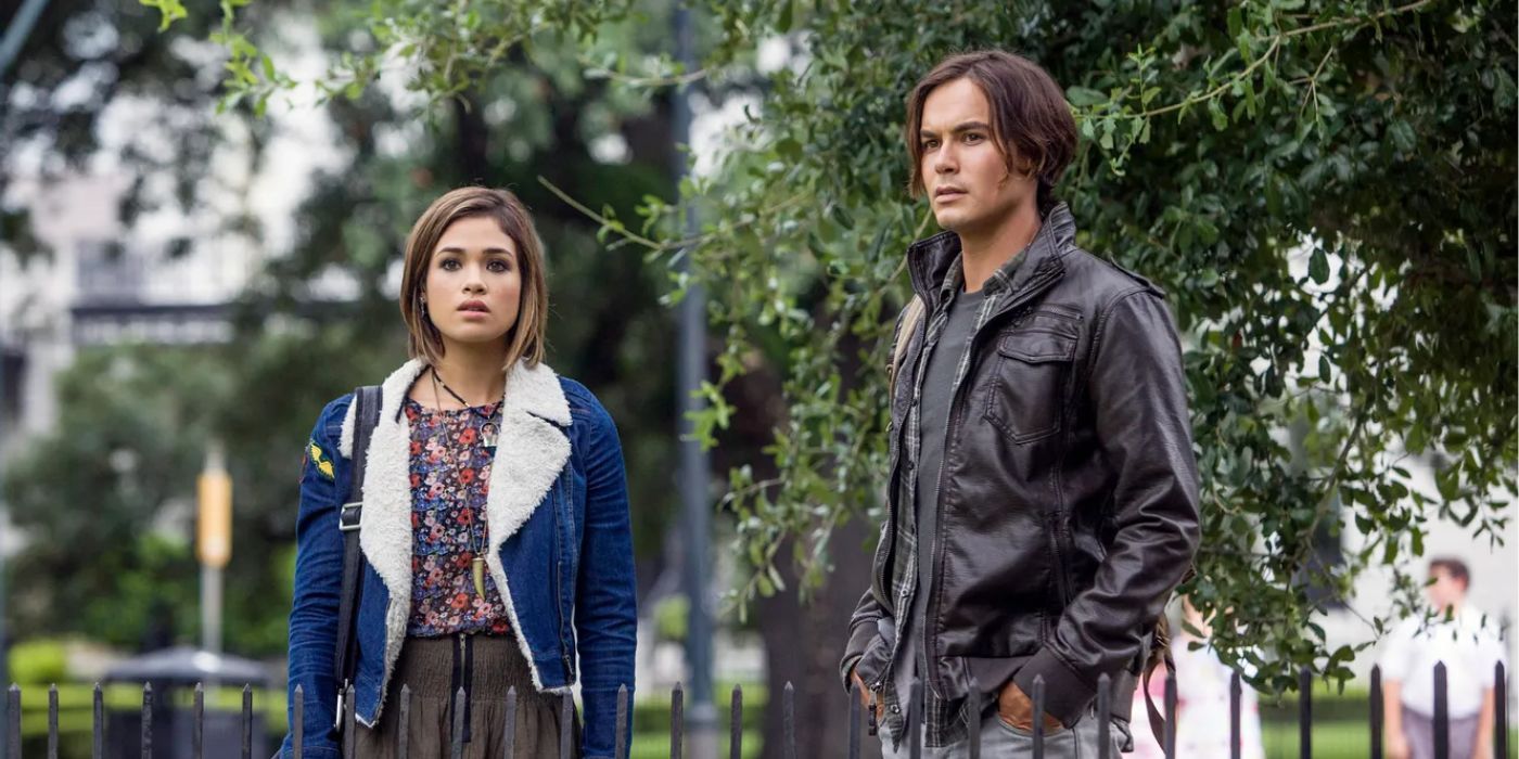 Tyler Backburn in a leather jacket and next to Nicole Gale Anderson in 
