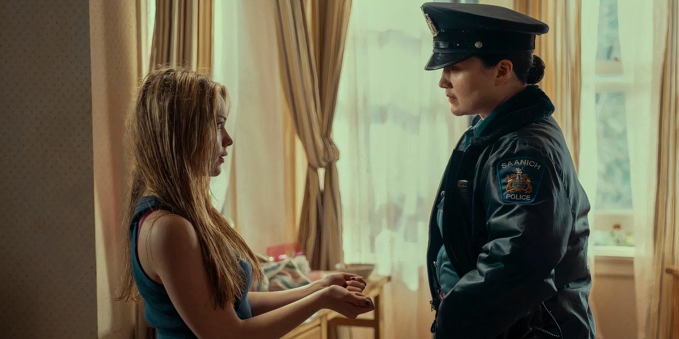 Jo holds out her hands so the officer played by Lily Gladstone can cuff her in a scene from 'Under the Bridge.'