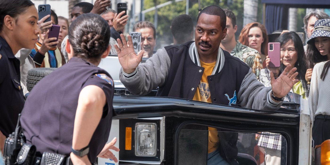 Eddie Murphy holds up his hands as cops draw their guns in Beverly Hills Cop: Axel F