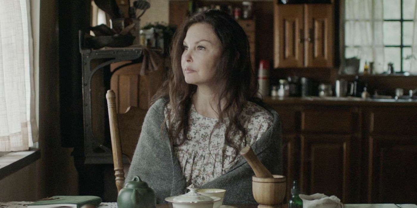 Ashley Judd sits at the kitchen table with a shawl wrapped around her shoulders in Lazareth