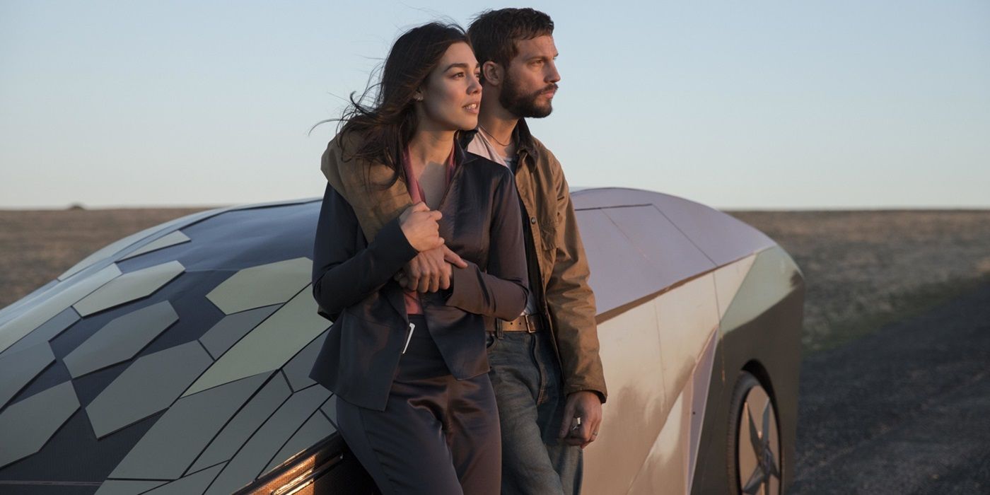 Grey Trace and Asha Trace leaning on a self-driving car, arms around each other, in Upgrade
