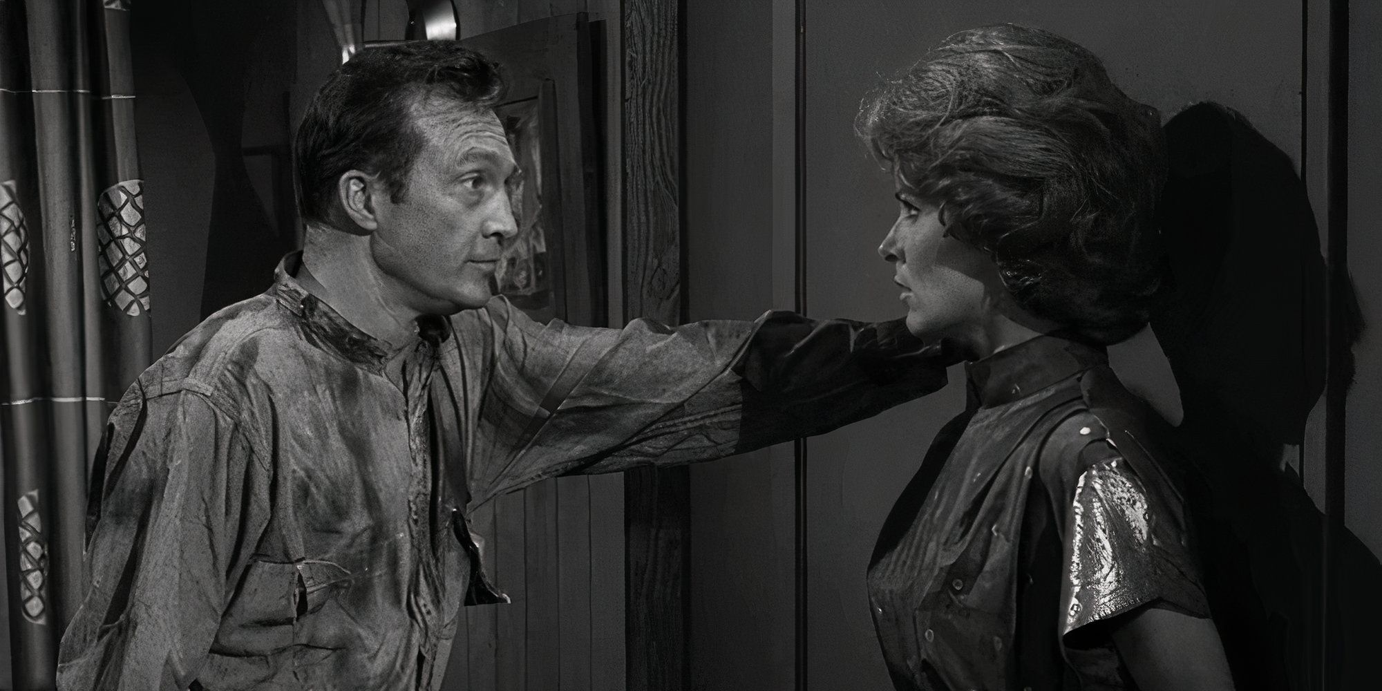 Warren Stevens looking at Joan Marshall who is backed up against a door in The Twilight Zone