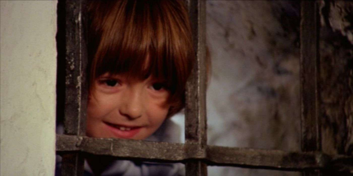 A young child looking through a window in Who Can Kill A Child