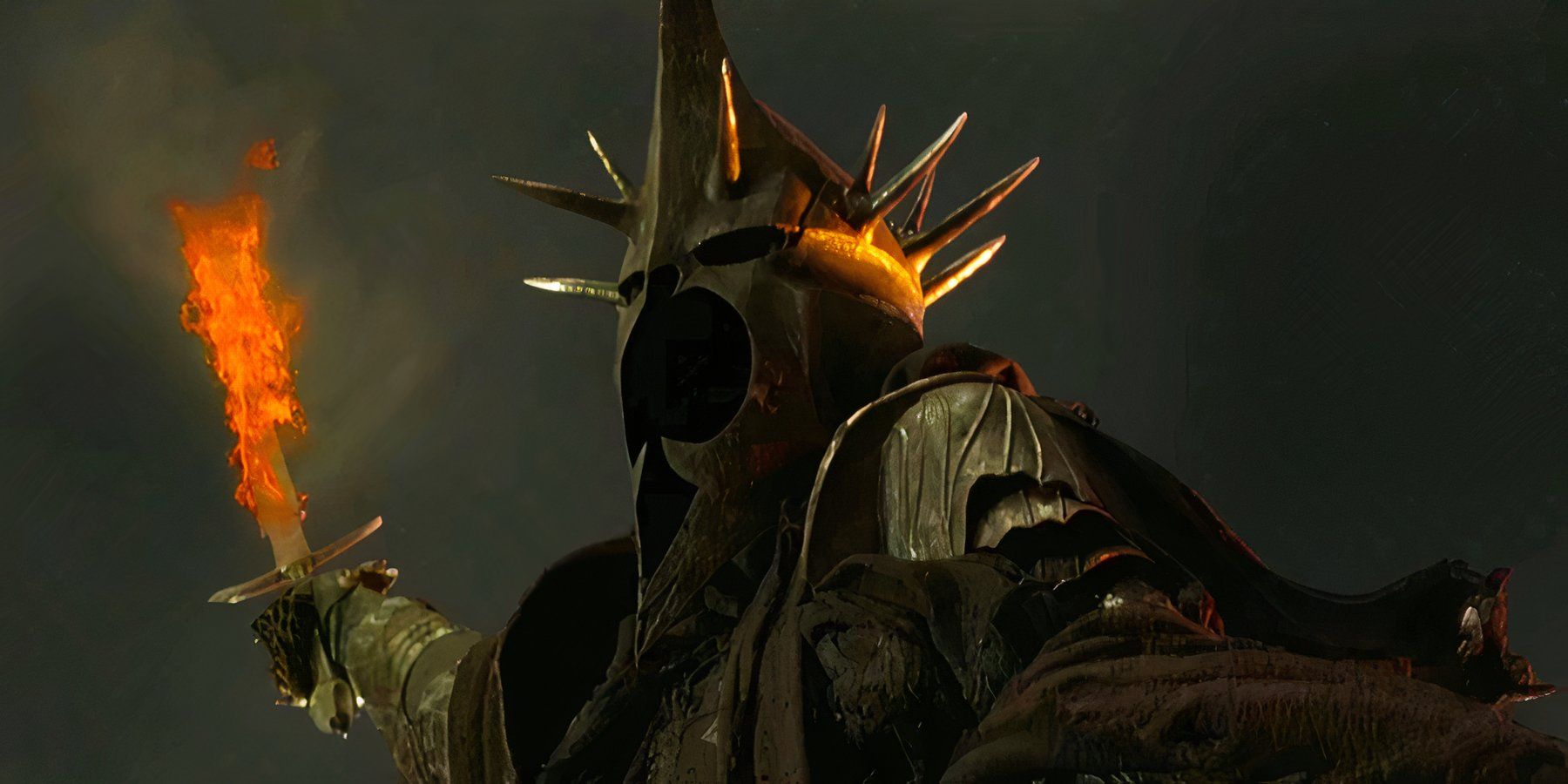 The Witch King of Angmar, played by actor Lawrence Makoare, raises his flaming sword into the air in The Lord of the Rings: The Return of the King.