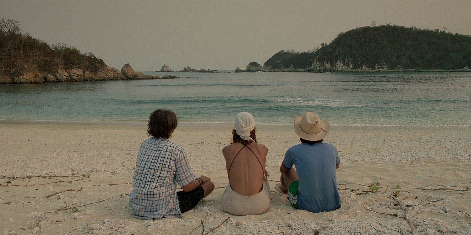 Tenoch, Julio, and Luisa all sitting on the beach together in 'Y Tu Mama Tambien' (2001)