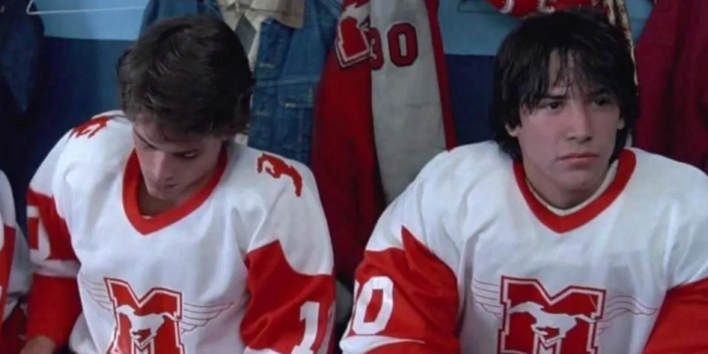 Rob Lowe as Dean Youngblood and Keanu Reeves as Heaver sitting together on a hockey bench in 'Youngblood'