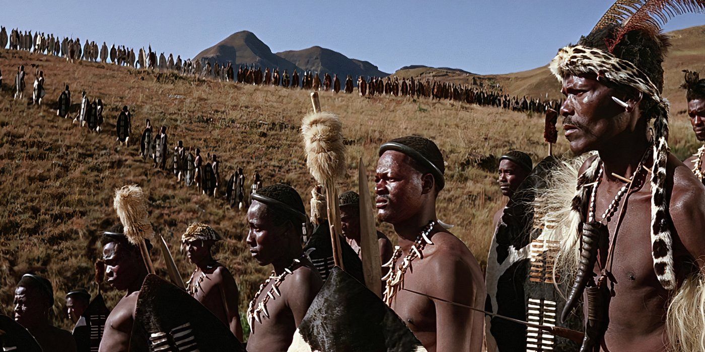 A contingent of Zulu warriors arrives from the hills, weapons raised