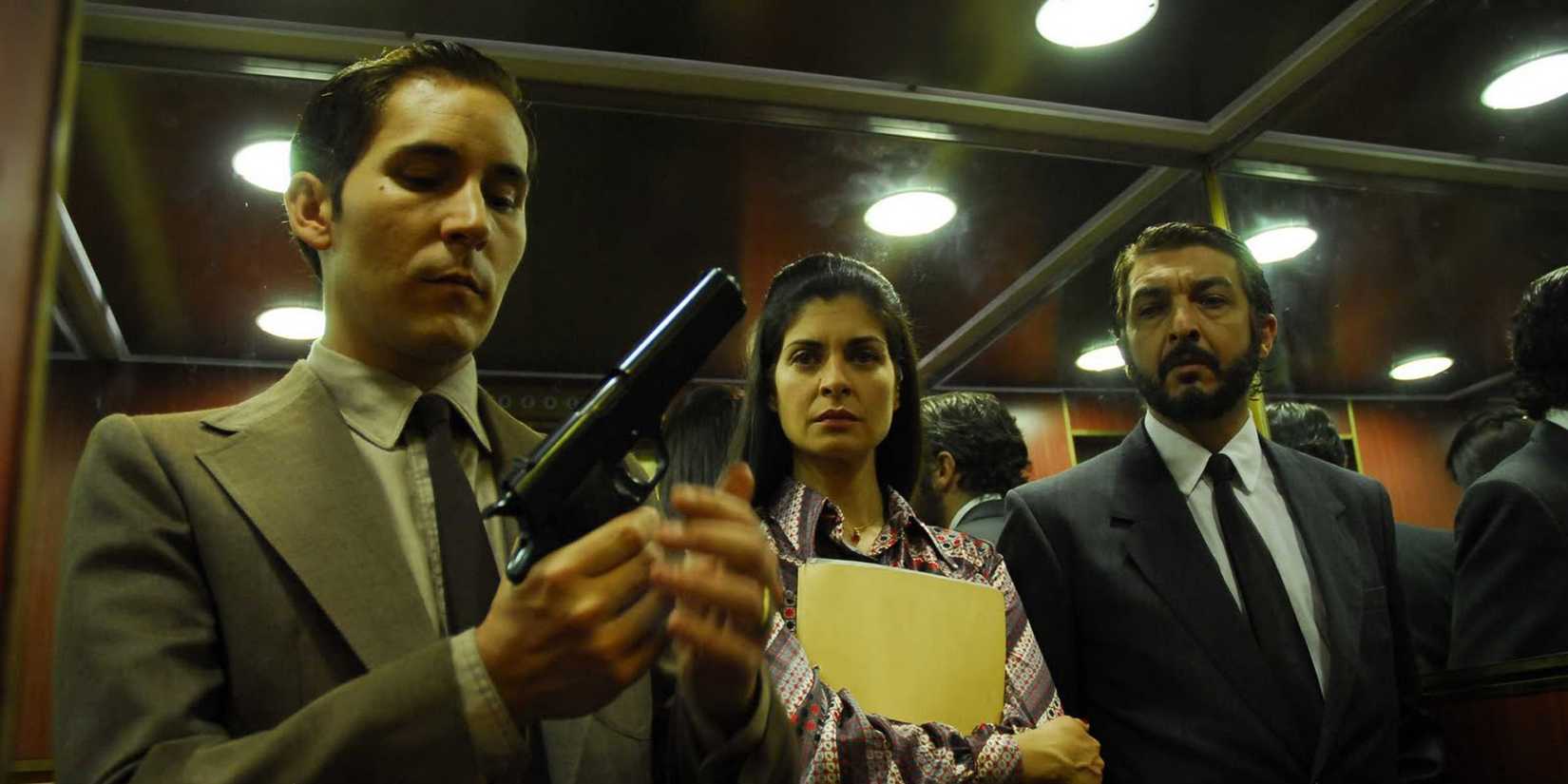 Soledad Villamil and Ricardo Darin as Irene and Esposito star as Gomez, played by Javier Godino, pulls out a gun in an elevator in The Secret in Their Eyes