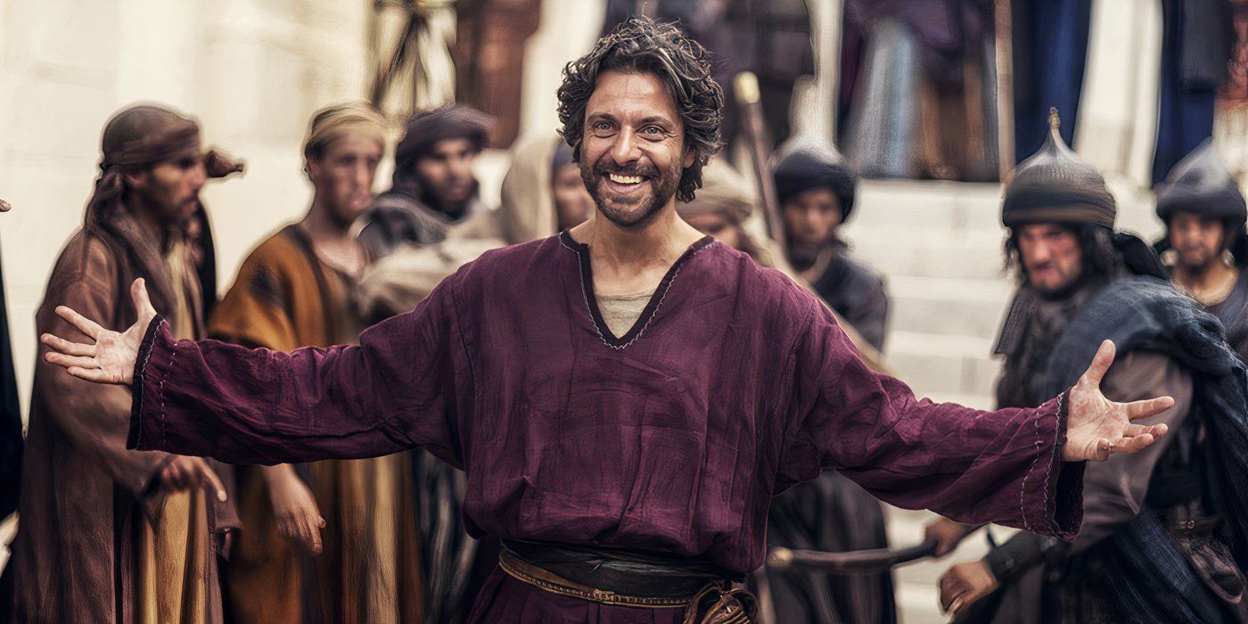 A man in A.D. The Bible Continues holding his hands out smiling to greet people with an angry mob behind him