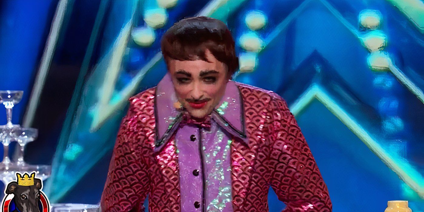Sweaty Eddie from America's Got Talent smiling with a bright sparkly outfit and loud make-up.