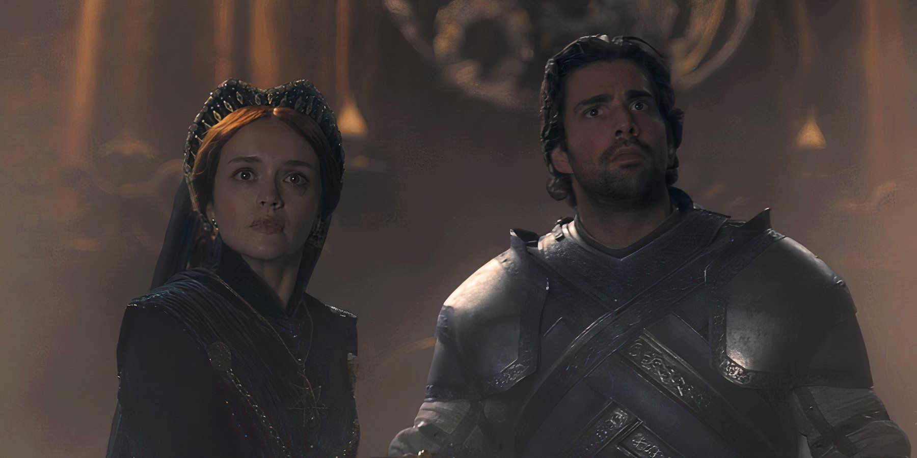 Alicent (Olivia Cooke) and Criston Cole (Fabien Frankel)looking up in horror in House of the Dragon