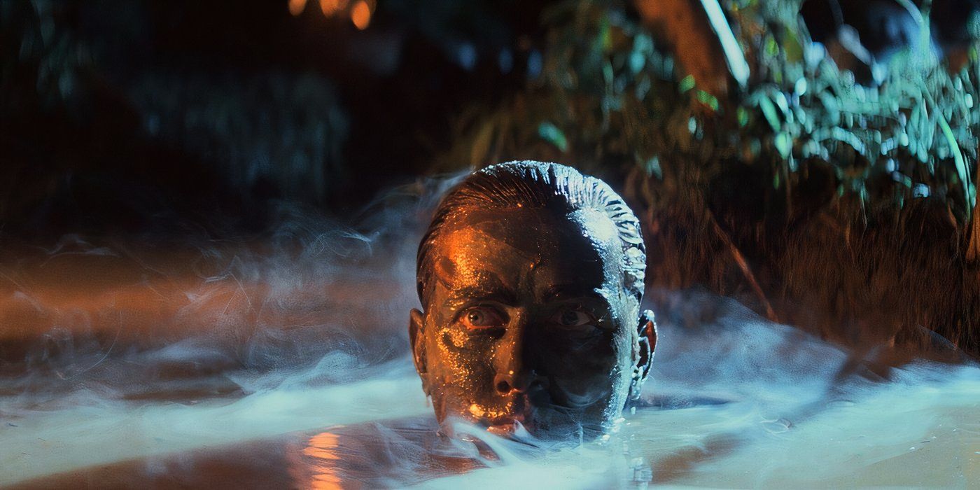 Benjamin (Martin Sheen) sneaks through a muddy brook with his face camouflaged in paint in Apocalypse Now.