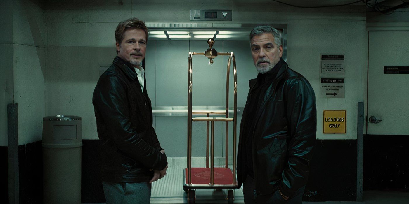 Brad Pitt and George Clooney standing in front of a parking garage elevator looking over.