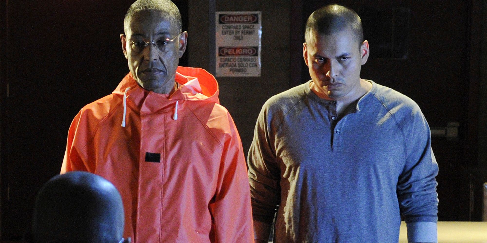 Gus Fring (Giancarlo Esposito) and Victor (Jeremiah Bitsui) standing next to each other in Breaking Bad