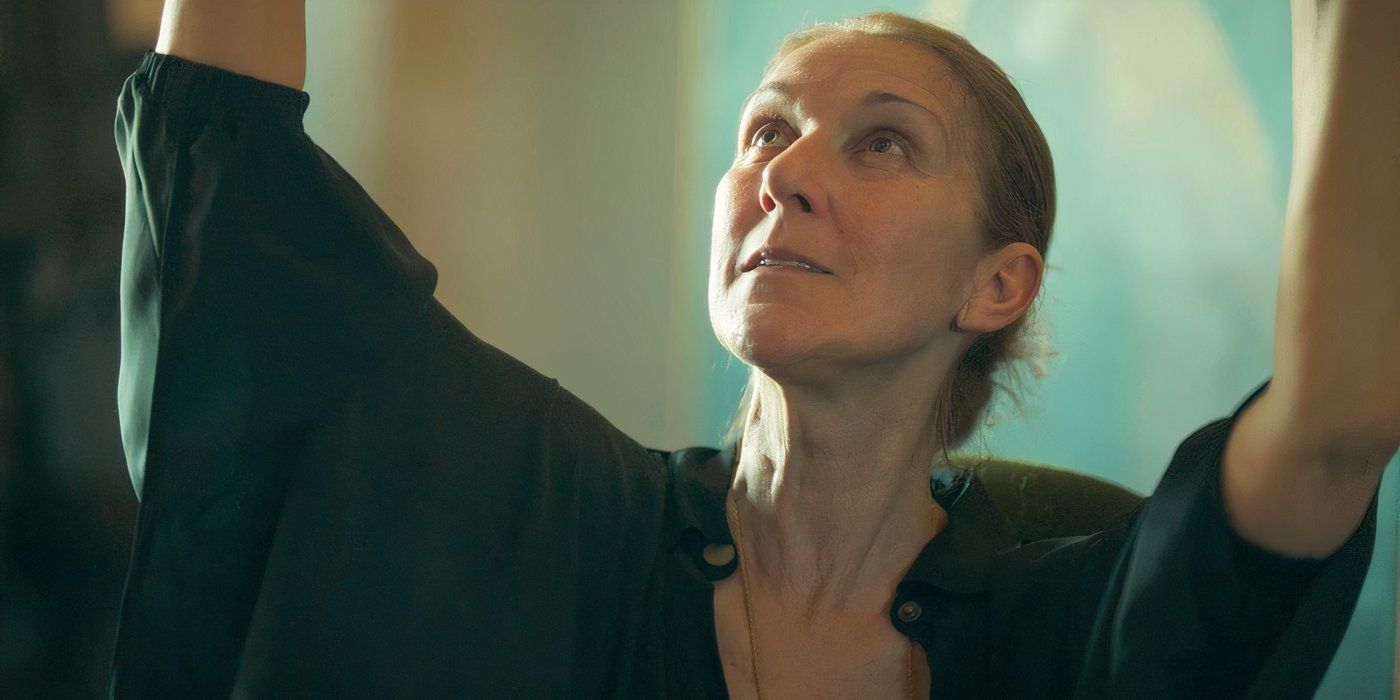 Celine Dion looking up with her arms above her head in still from 'I Am: Celine Dion'.