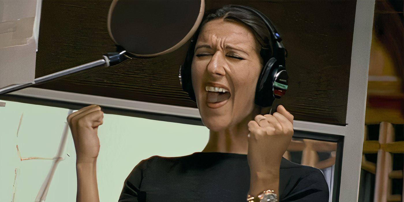 Celine Dion singing in a studio with clenched fists