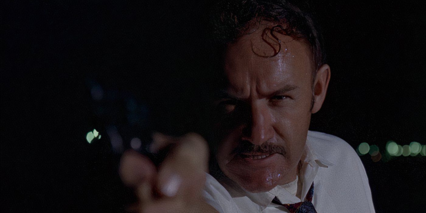 Gene Hackman as Sergeant Leo Holland aiming his gun at an off-screen target in Cisco Pike (1971)