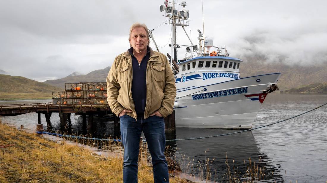 Captain Sig Hansen stands by the shore in front of his vessel Northwestern on Season 20 of Deadliest Catch.