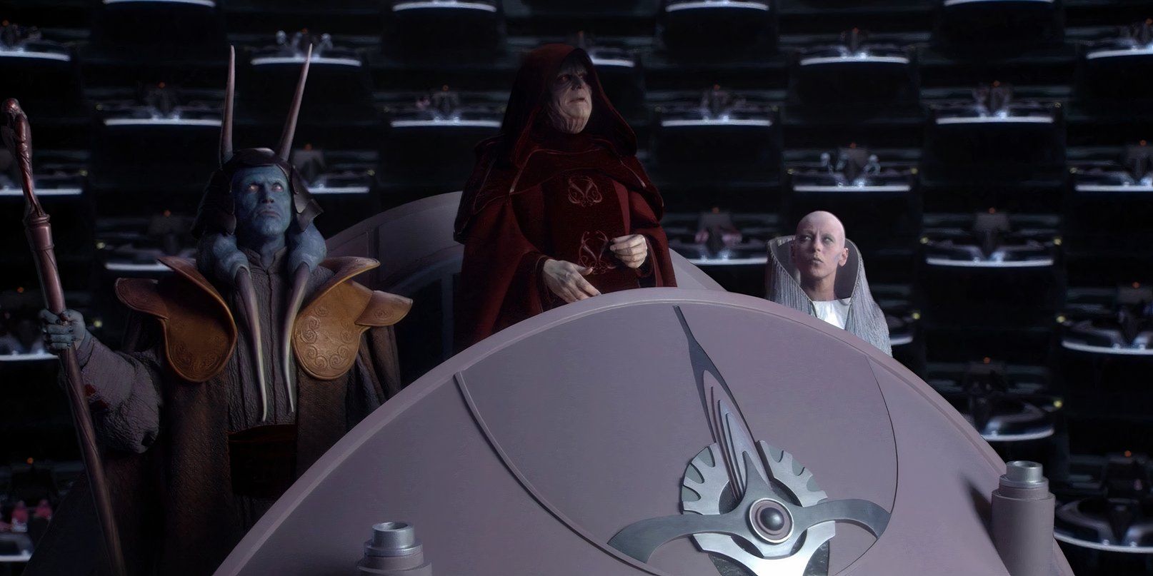 Palpatine adresses the senate in a red robe, surronded by his advisers 
