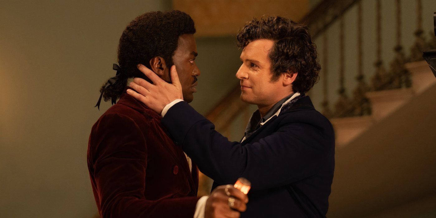 A profile image of Rogue (Jonathan Groff) cupping the Doctor's (Ncuti Gatwa) neck and cheek with his hand while smiling tenderly at him in Doctor Who