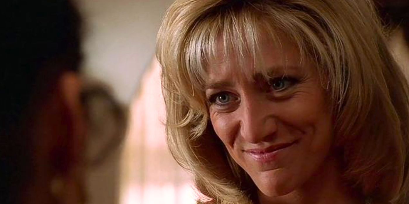 Edie Falco as Carmela Soprano grins to person off screen in the episode Full Leather Jacket from The Sopranos
