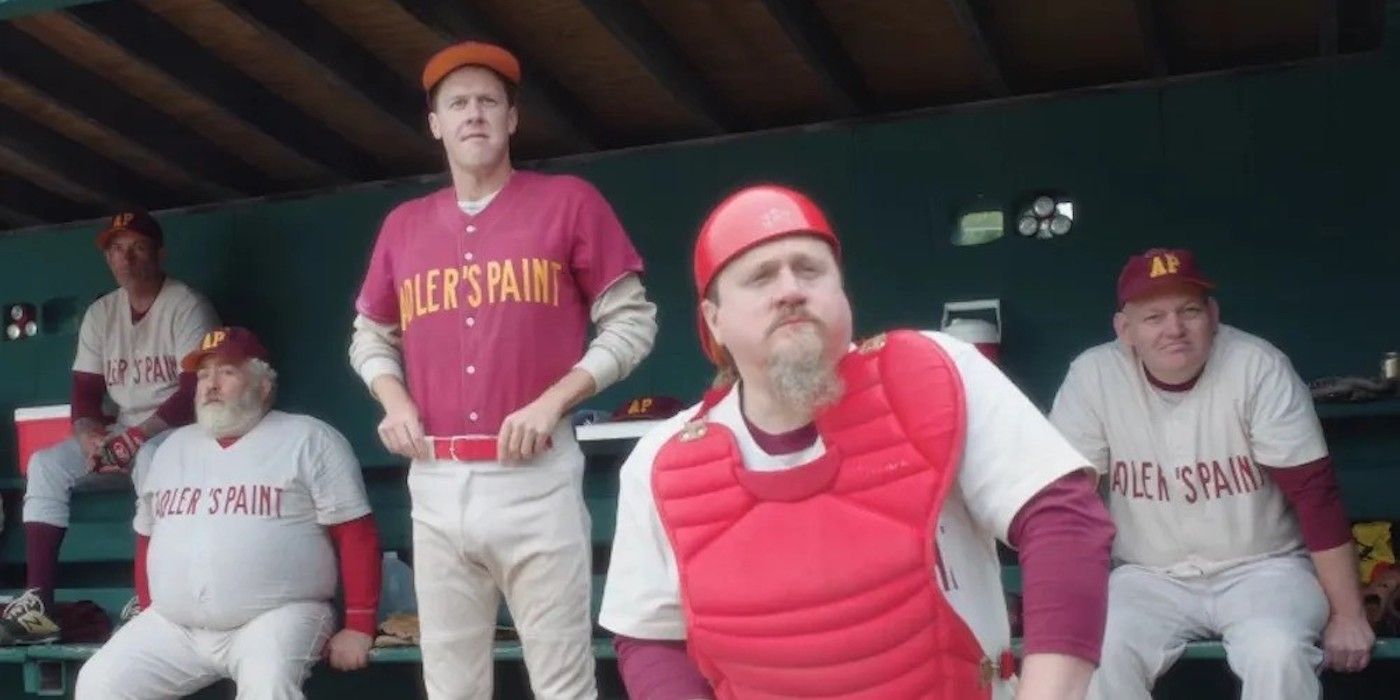 A group of men sit in a baseball dugout in a still from Eephus. 