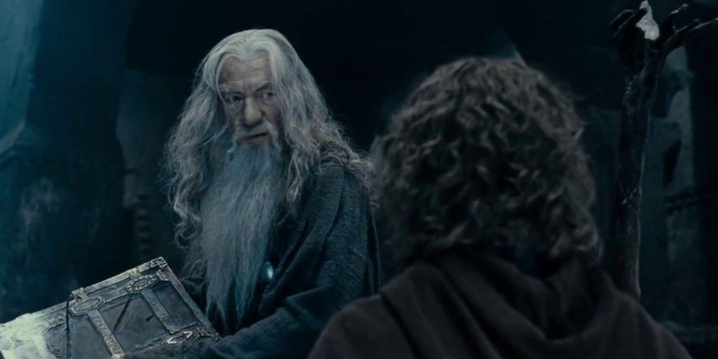 Gandalf (Ian McKellen) slams shut a book and scowls at Pippin (Billy Boyd) in the Mines of Moria in 'The Lord of the Rings: The Fellowship of the Ring' (2001).