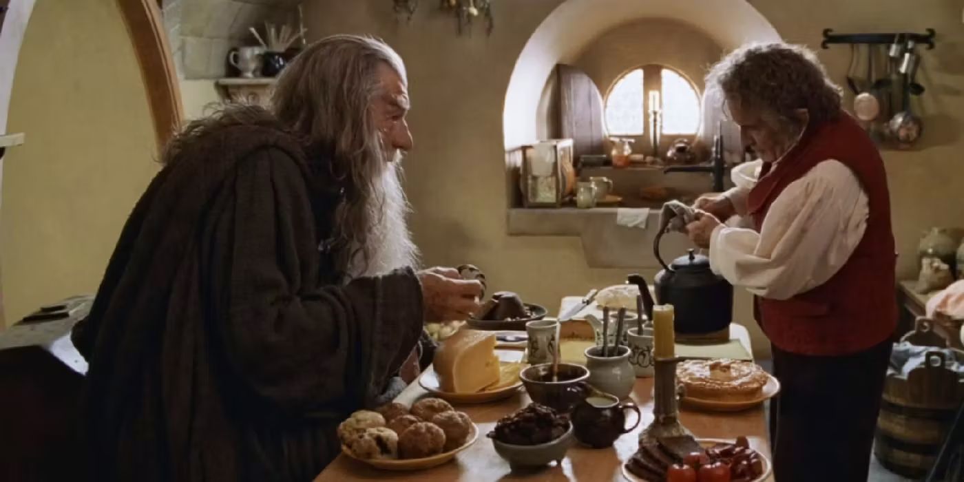 Gandalf the Grey (Ian McKellen) sits at Bilbo's (Ian Holm) dining table as the two old friends chat over a meal in 'The Lord of the Rings: The Fellowship of the Ring' (2001).