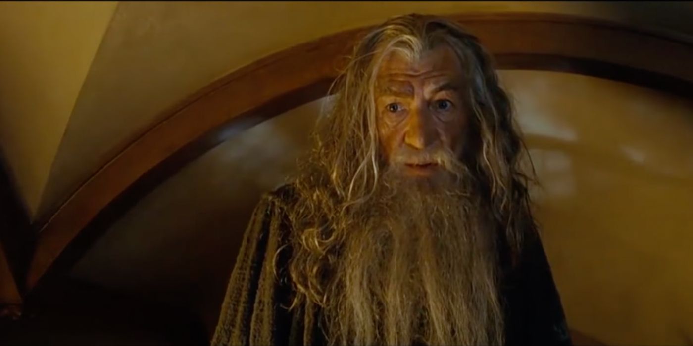 Gandalf the Grey (Ian McKellen) stands in Frodo's fire-lit home, casting a look of dread as he recites the text on the ring in 'Lord of the Rings: The Fellowship of the Ring' (2001).