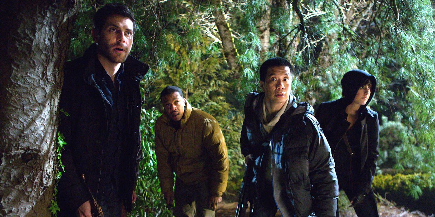Nick Burkhardt (David Giuntoli) stands by a tree as he and his friends creep through the woods at night in 'Grimm' Season 4, Episode 22 "Cry Havoc" (2015).