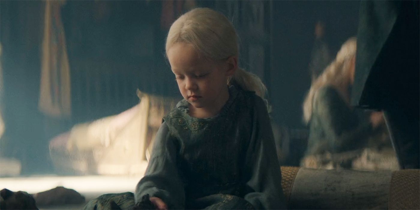 Jaehaera Targaryen sitting and playing on the ground in House of the Dragon