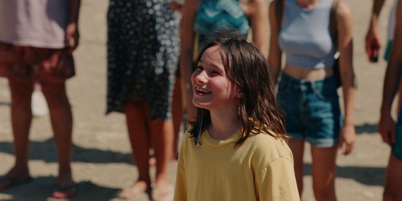 Frankie Corio as Sophie smiling and looking up at her dad in a still from Aftersun.